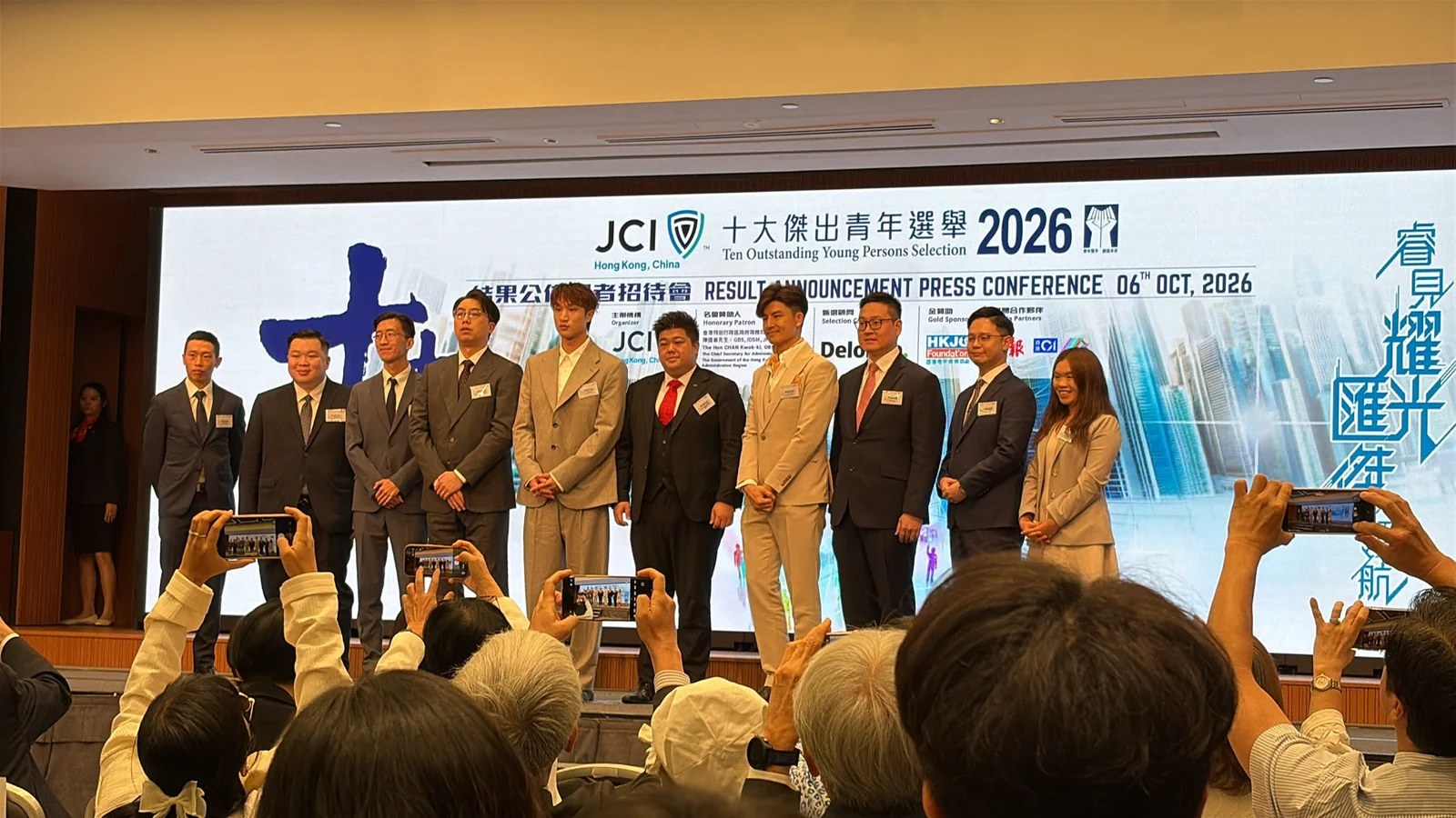 People on stage at the Hong Kong TOYP 2026 results-announcement press conference, photographed from the audience.